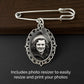 A silver wedding bouquet photo charm pin with an ornate oval frame and a guardian angel wing shown on a dark wood and black background. The frame contains a sample black-and-white portrait photo, and text at the bottom reads, 'Includes photo resizer to easily resize and print your photos.'