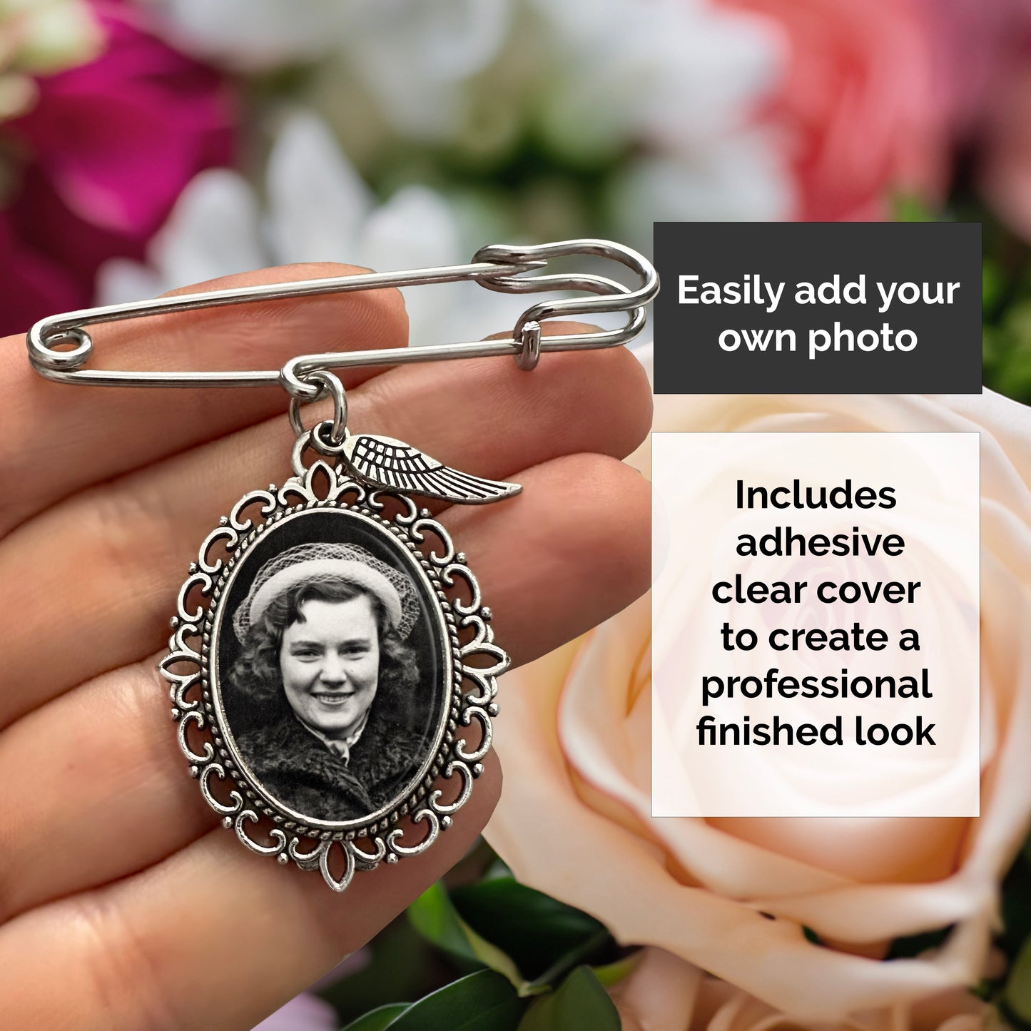 A hand holds a silver-toned wedding bouquet photo charm with safety pin top with an oval decorative frame and a sample black-and-white photo in the frame. Text overlays explain that a user can easily add their own photo and that adhesive clear covers are included to create a professional finished look.