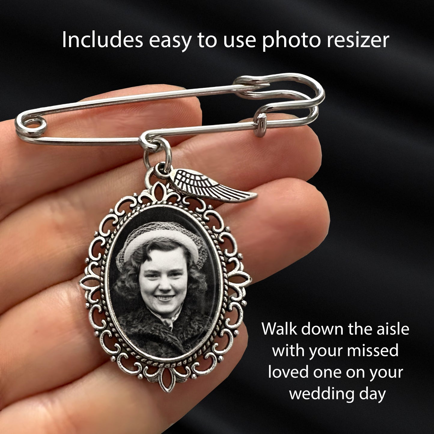 A silver-toned safety pin brooch wedding photo charm with an oval decorative frame holding a black-and-white portrait photo, shown resting on a person's fingers against a dark fabric background. Text overlays read 'Includes easy to use photo resizer' and 'Walk down the aisle with your missed loved one on your wedding day.