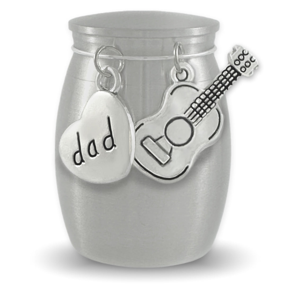 A brushed silver small stainless steel urn shown on a white background, A heart-shaped charm engraved with 'dad' and a guitar-shaped charm hang from the top.