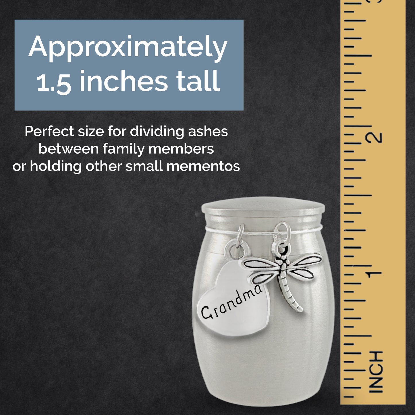A small silver urn, decorated with a silver dragonfly charm and a heart tag that says 'Grandma', shown on a dark textured background with a yellow inch ruler and text stating it is approximately 1.5 inches tall.