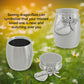 Small stainless steel urn with grandma and dragonfly charms shown both closed and open on a background with flowers in a meadow. The text reads 'Seeing dragonflies can symbolize that your missed loved one is near and watching over you.'