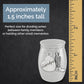 A small keepsake urn with grandpa and cowboy boot charms shown on a dark textured background with a wooden ruler along the right side and text stating it is approximately 1.5 inches tall.