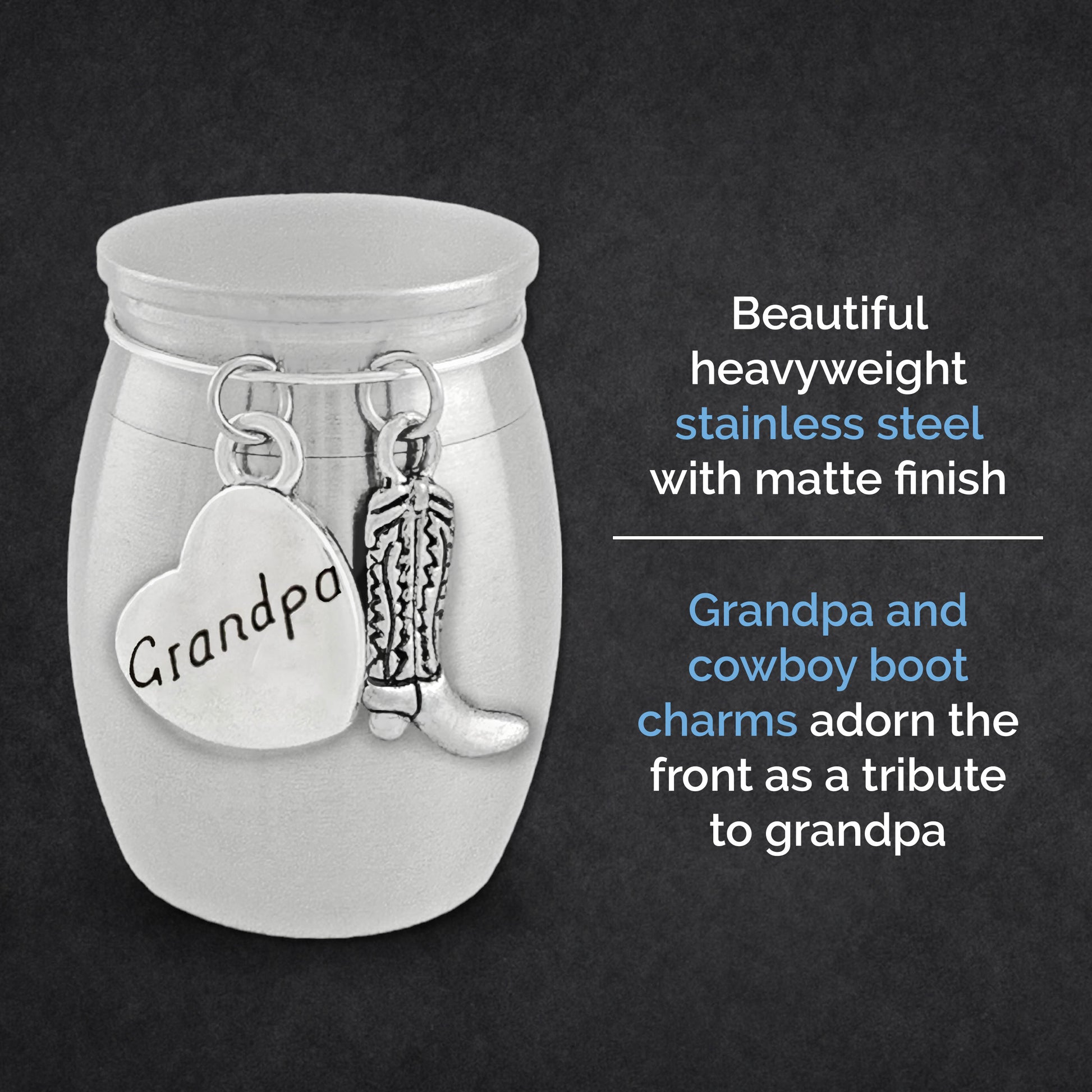 A silver small memorial urn jar with a matte finish, featuring engraved and shaped charms on the front: a heart charm reading 'Grandpa' and a cowboy boot charm. Text on a dark background describes the product as a stainless steel tribute jar with these charms.