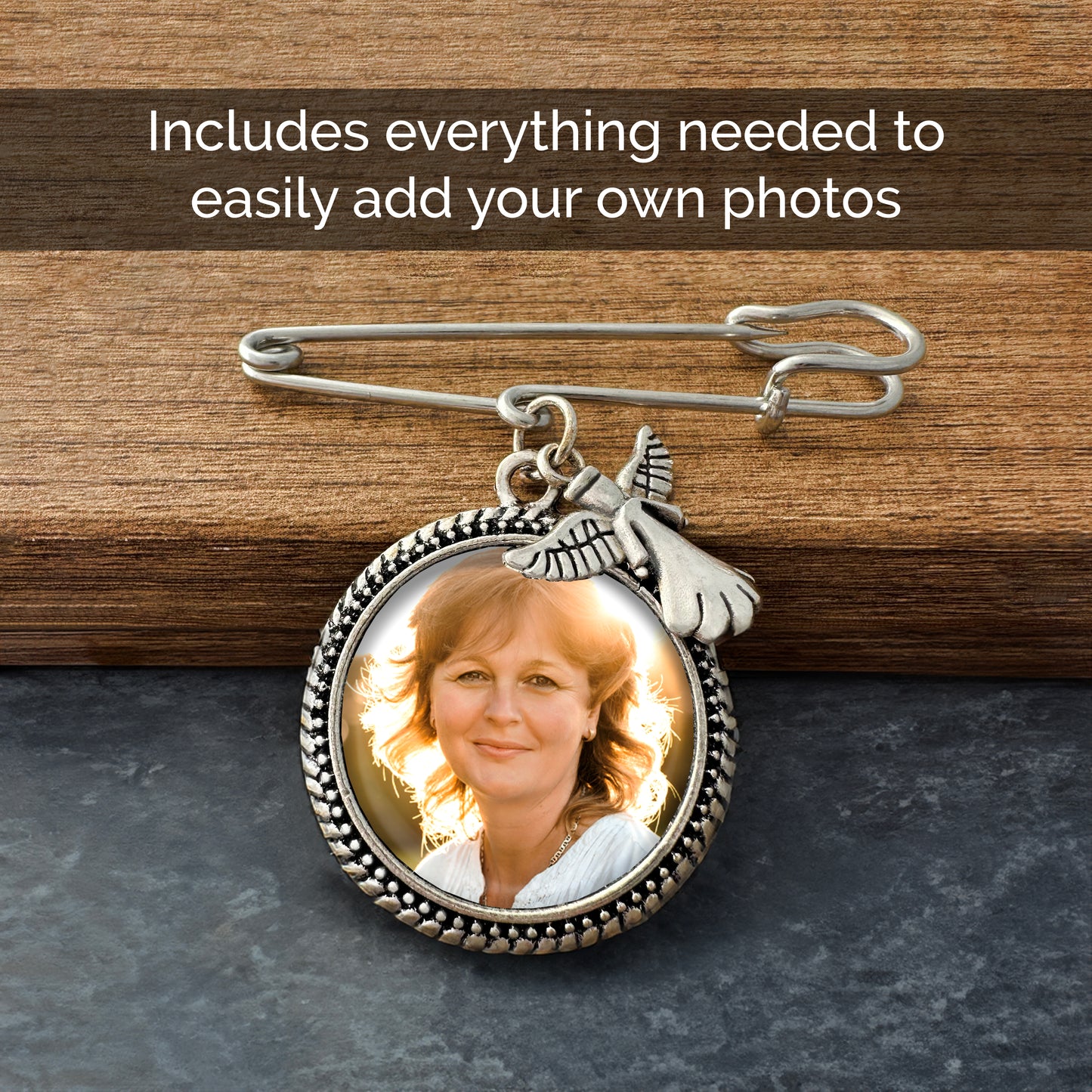 Memorial photo pin leaning against a wooden ledge. Text banner reads Includes everything needed to easily add your own photos. The photo inside the frame is a woman. There is a guardian angel charm sitting at the top of the frame. There is a safety pin style top for attaching to your wedding bouquet or grooms boutonniere.