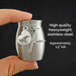 A hand holds a small stainless steel keepsake urn against a dark background, with text on the right reading 'High quality heavyweight stainless steel' and 'Approximately 1.5" tall.