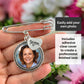 A silver-toned safety pin style brooch or charm accessory held in a hand, featuring a round photo frame with a portrait insert and a small heart charm marked 'Mom.' Text boxes explain that a custom photo can be added and that adhesive clear covers are included.