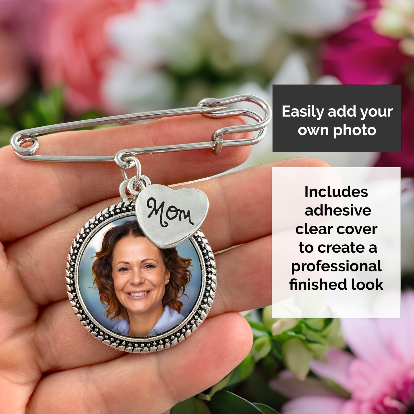 A silver-toned safety pin style brooch or charm accessory held in a hand, featuring a round photo frame with a portrait insert and a small heart charm marked 'Mom.' Text boxes explain that a custom photo can be added and that adhesive clear covers are included.