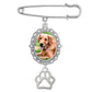 Silver brooch with a photo of a dog and a paw print on a white background