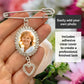 A silver wedding bouquet photo charm held in a hand, featuring an oval frame with a sample portrait photo, rhinestone detailing, and a dangling heart charm. Text overlays explain that the customer can easily add their own photo and that it includes an adhesive clear cover.