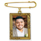 Gold-framed photo pin with a man's portrait on a white background